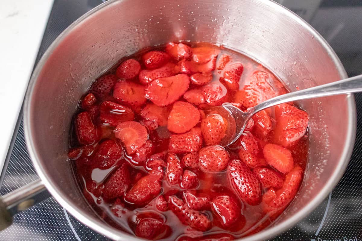 How To Make Strawberry Sauce | thewendthousekitchen.com Strawberries, sugar and water mixed together in a medium saucepan.