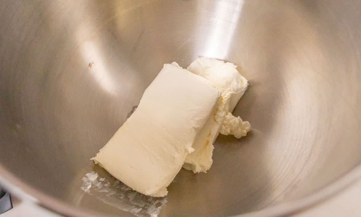 3 Ingredient No Bake Cheesecake | thewendthousekitchen.com Two bricks of softened cream cheese in the bowl of a stand mixer.