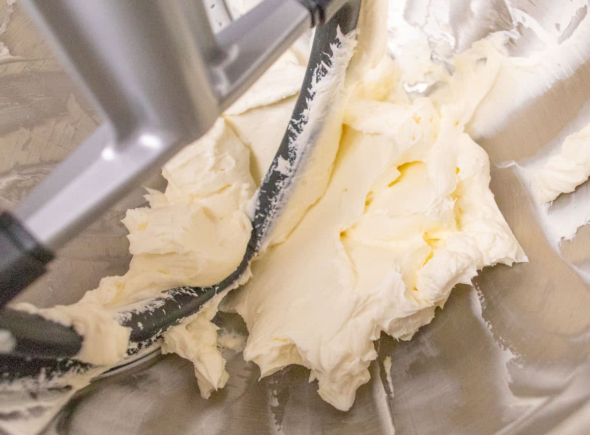 3 Ingredient No Bake Cheesecake | thewendthousekitchen.com Beating cream cheese in the bowl of a stand mixer.