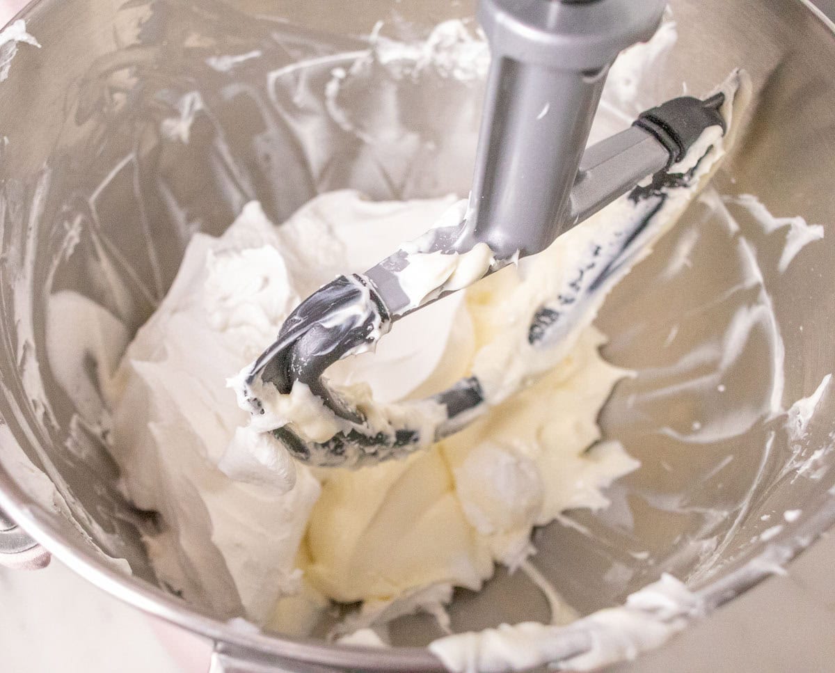 3 Ingredient No Bake Cheesecake | thewendthousekitchen.com Cool Whip topping added to the bowl of the stand mixer with the cream cheese and powdered sugar.
