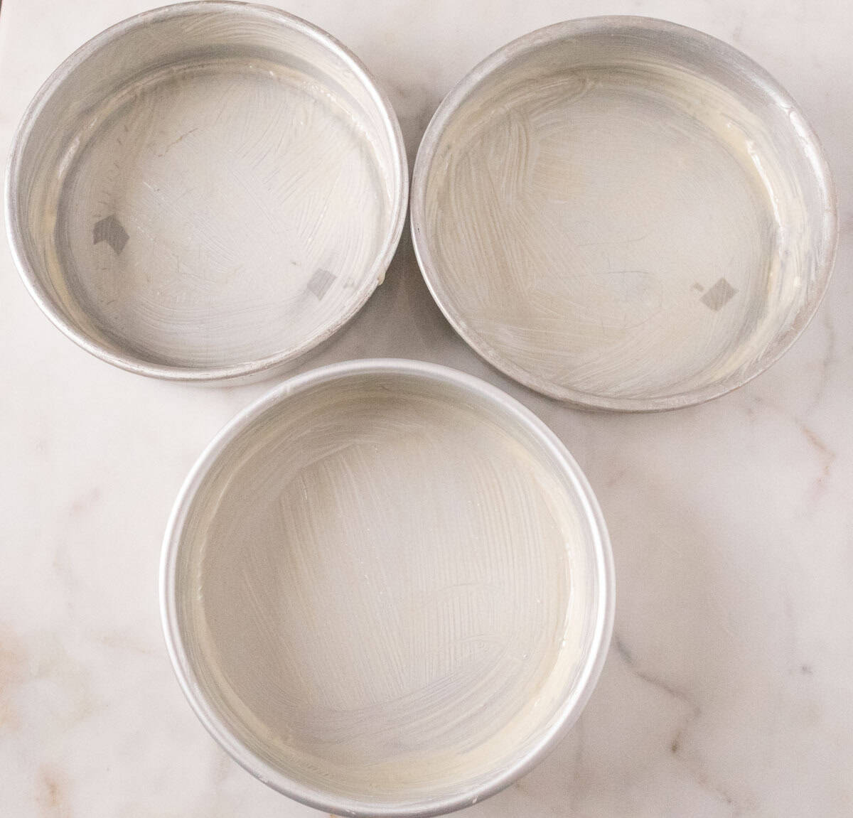 Strawberry Crunch Cake | thewendthousekitchen.com Three 8-inch round cake pans greased with cake release.