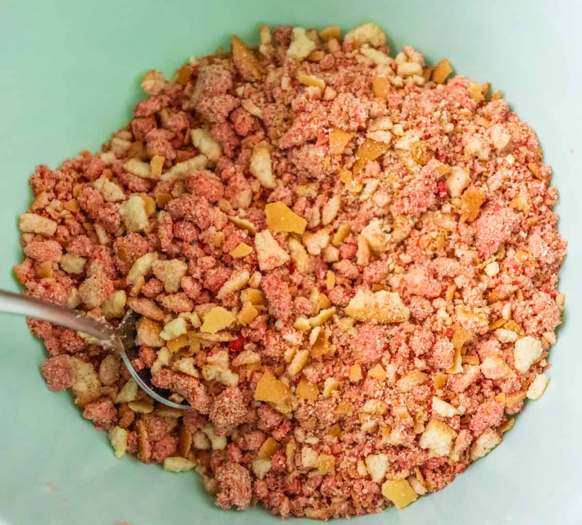 Strawberry Crunch Cake | thewendthousekitchen.com Finished strawberry crunchies in a medium light turquoise mixing bowl.