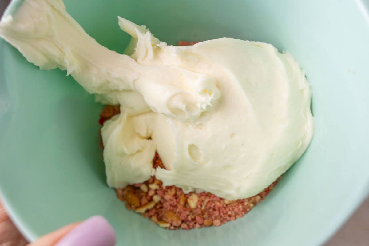 Strawberry Crunch Cake | thewendthousekitchen.com Strawberry crunchies and buttercream in a medium mixing bowl.