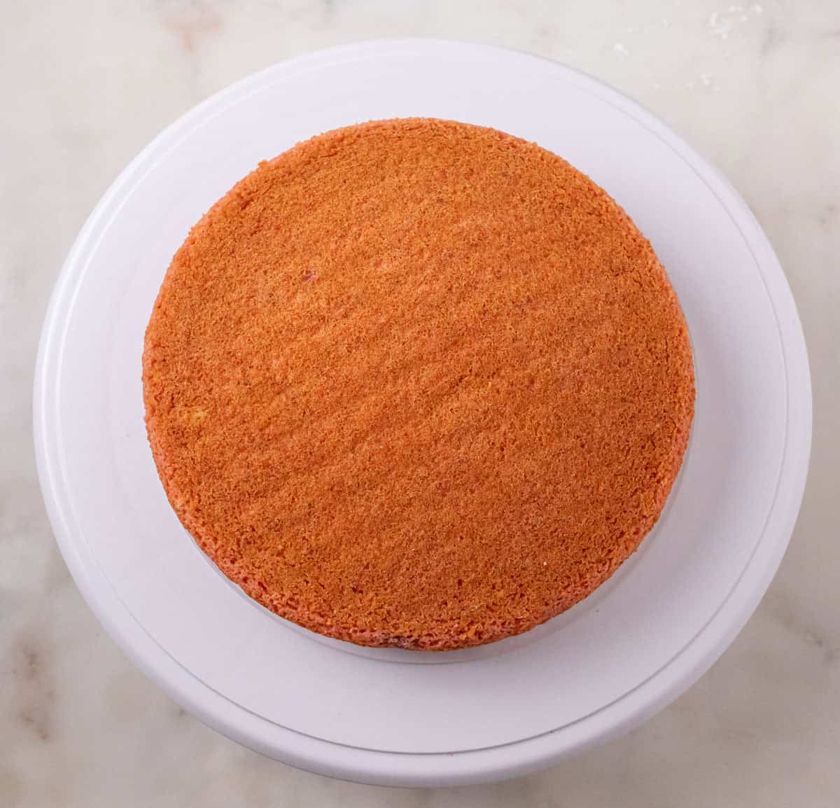 Strawberry Crunch Cake | thewendthousekitchen.com 8-inch cake layer on a cake turntable.