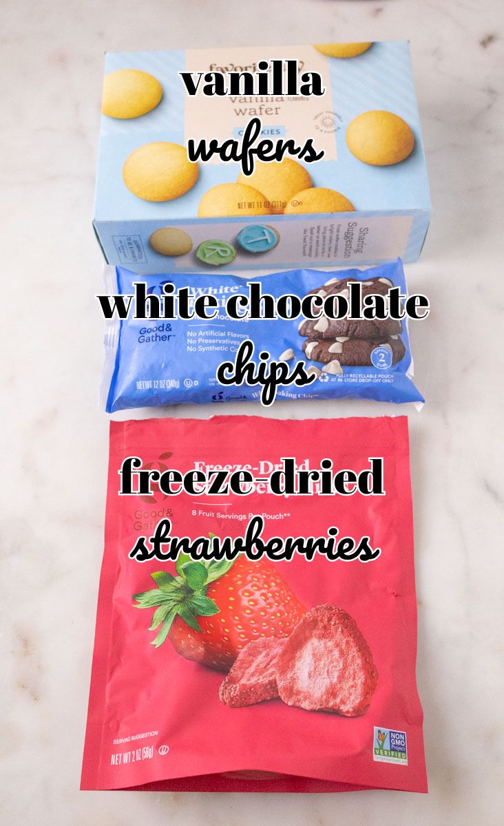 Strawberry Crunch Cake | thewendthousekitchen.com Ingredients for strawberry crunchies (vanilla wafers, white chocolate chips and freeze-dried strawberries) labeled.